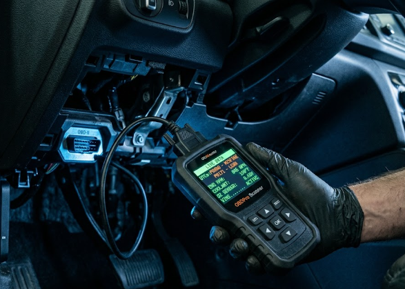 Valise de diagnostic électronique branchée sur la prise OBD d'un véhicule